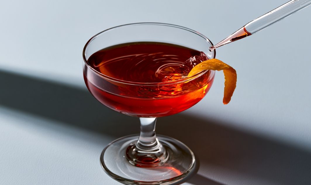 A cocktail with an orange twist